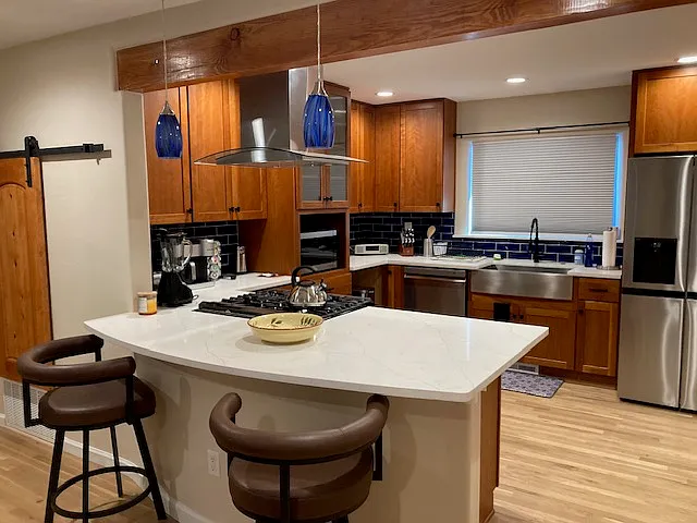 Kitchen view stocked with new appliances and all cooking needs.