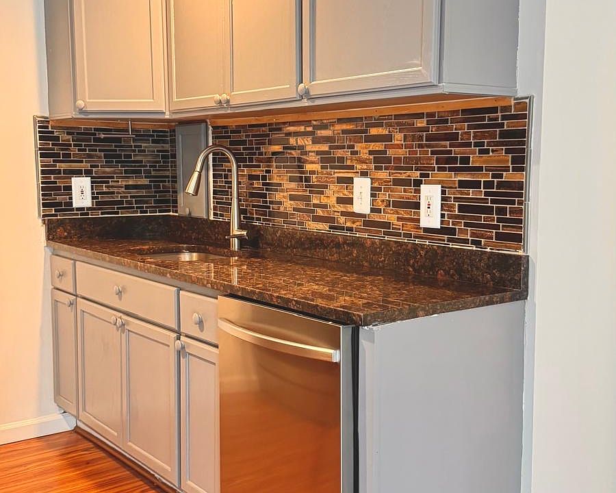 Updated kitchen with stainless steel appliances, granite countertops, beautiful backsplash and modern cabinets!