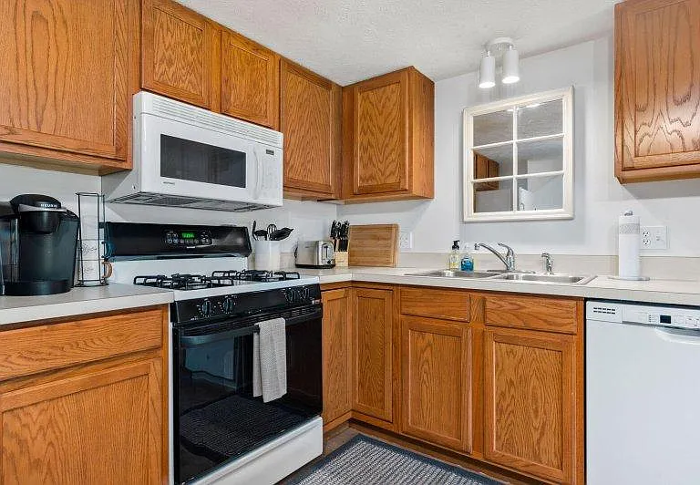 Kitchen with microwave, gas range and oven, disposer and dishwasher