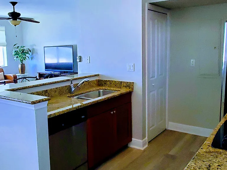 Kitchen looks out to water and family room