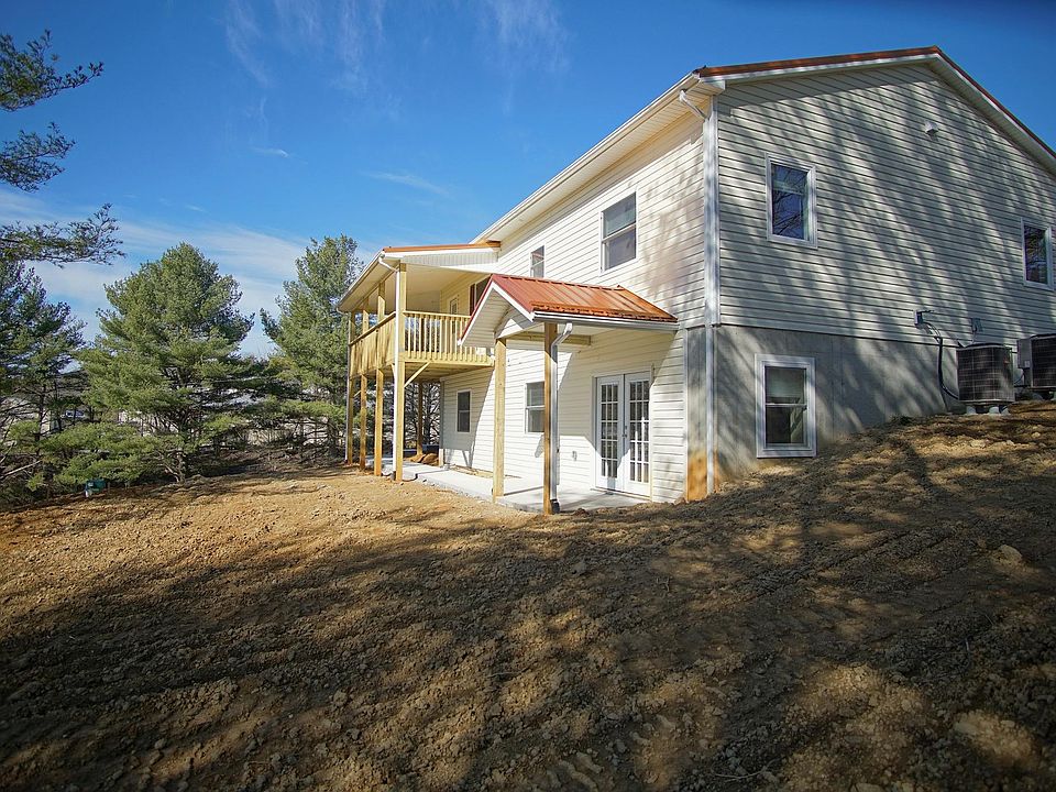 Wrap around covered porch. Separate sidewalk entrance to lower level through french doors. Yard has been seeded and landscaped since photos.