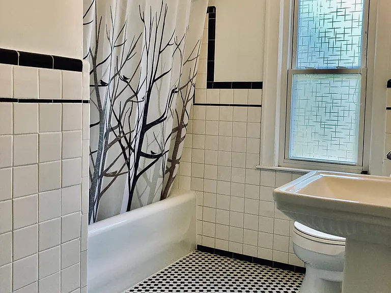 View of the second-floor full bathroom which receives light from the window on side of the house.