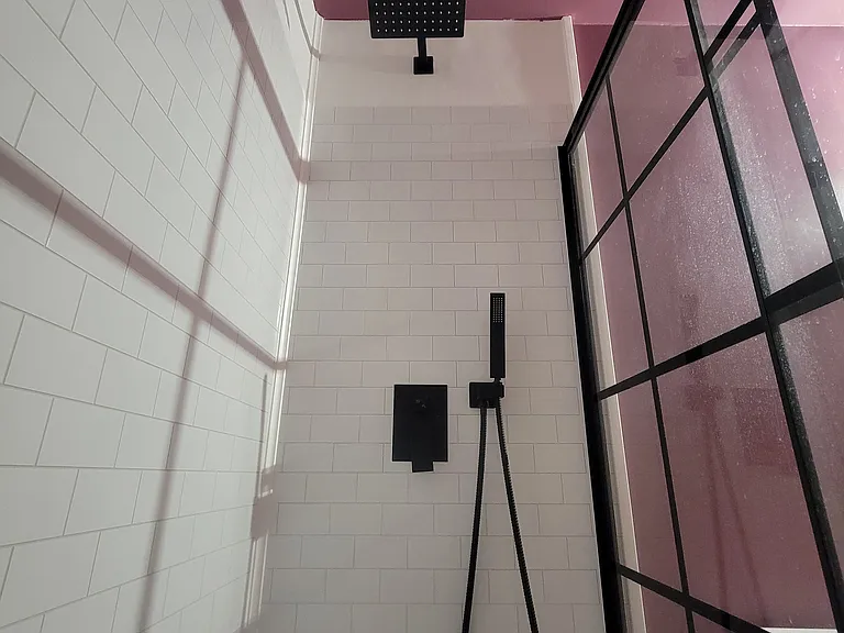 Rainfall showerhead and sleek black fixture.