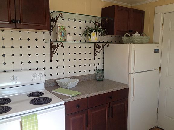 This is a photo of the kitchen but it does not show the very cool floor. We realize that we do not have many photos of this unit because the person living here has been here so long and has loved it. Now its full of boxes so it does not photograph well.