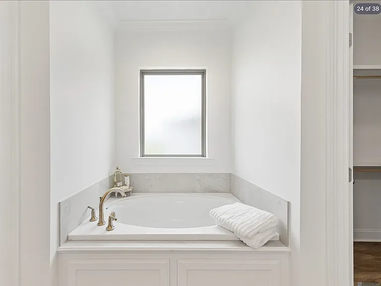 Spacious primary bedroom featuring a private en-suite bathroom with a relaxing garden tub, creating the perfect retreat at the end of the day.