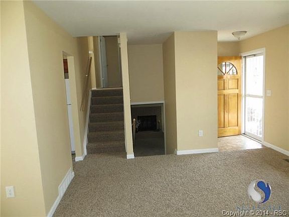 Living room with stairs to upper level; stairs to family room.
