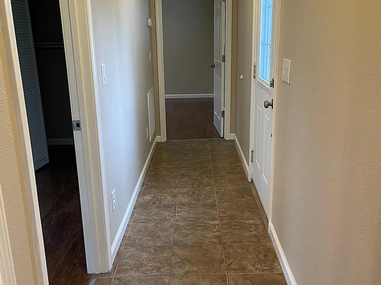 Hallway showing first bedroom on left and master in the back