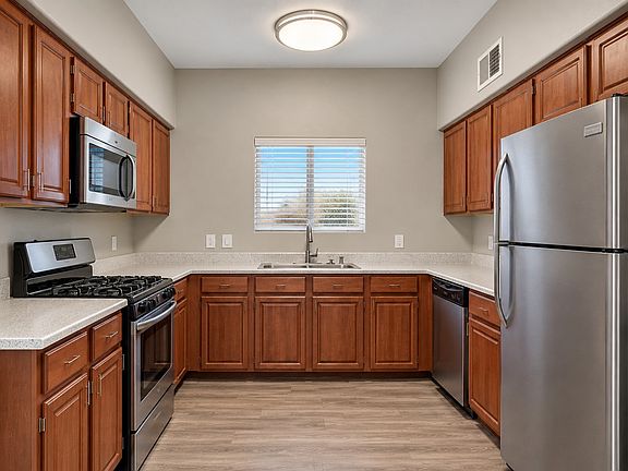Step into modern living at Arroyo Grande with this stylish kitchen featuring sleek stainless steel appliances and elegant wood cabinetry. Perfect for culinary enthusiasts, this space effortlessly combines functionality and design. Explore your new home to