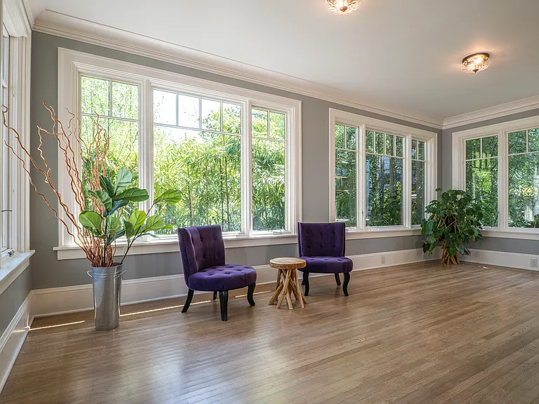 Sun room on main floor facing the back yard and park. Great for coffee, work, or working out.