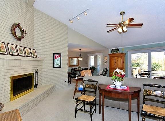 Corner Fireplace in Vaulted Great Room is open to Formal Dining.