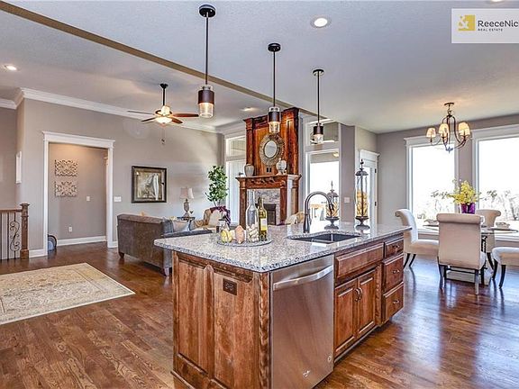 Kitchen has granite counter tops and stainless steel appliances. View into hall to the master suite. (Photo is of a previous model. Current home under construction)