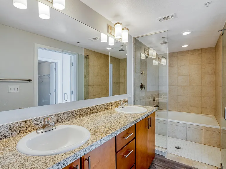 Bathrooms with quartz counters and tiled surrounds