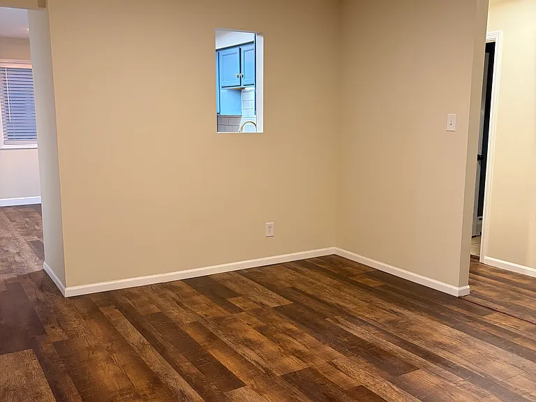 Living room from front doorway - see through window looking into the kitchen