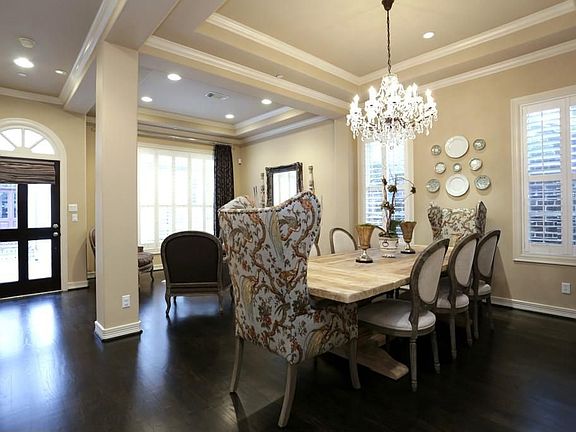 Light and bright dining room is open to the living room. Features gleaming hardwood floors, plantati