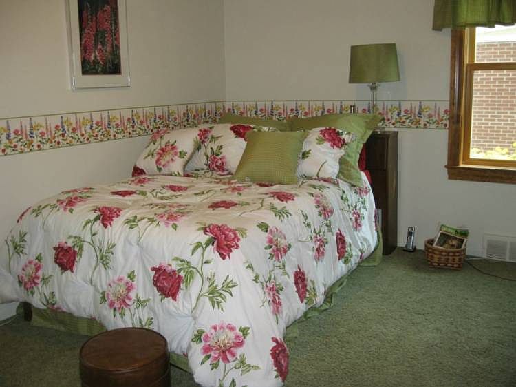 master bedroom with two nice sized windows for a nice breeze