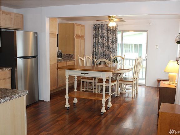 Open concept kitchen and dining room with front slider to a sitting area. Updated with stainless steel appliances and laminate flooring.  Just beautiful!