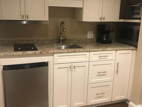 Plenty of storage. Complete supplies. Range w vented hood, microwave, countertop oven, refrigerator, garbage disposal.