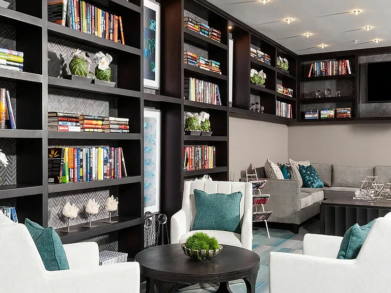Lounge with Floor-to-Ceiling Library Shelves and Modern Seating
