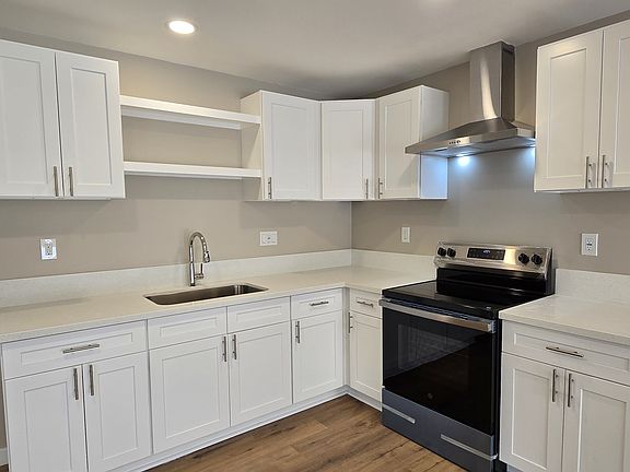 Brand new kitchen with plenty of cabinets and quartz counters