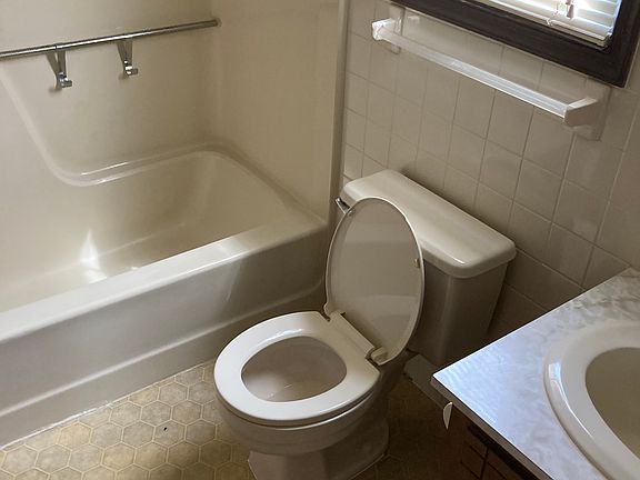 A full bath with window, tub and shower is adjacent to the large bedroom and next to the washer& dryer, off the kitchen
