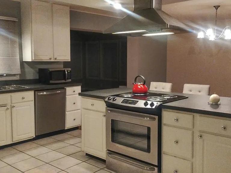 Multiple kitchen cabinets and stainless steel appliances.
