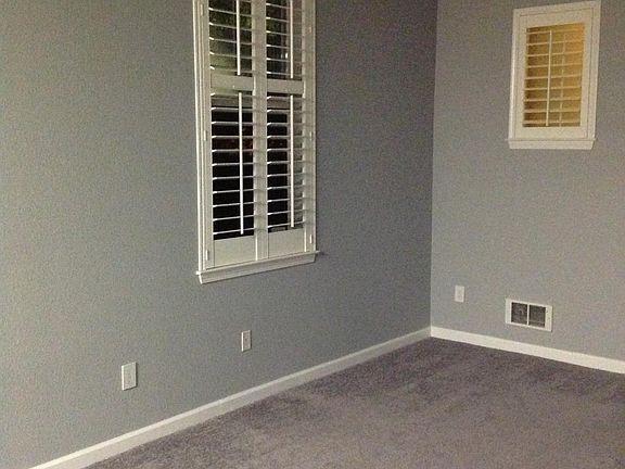 High ceilings/chandelier lighting/plantation shutters