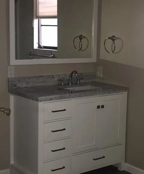 Marble countertop and soft close drawers in the bathroom.