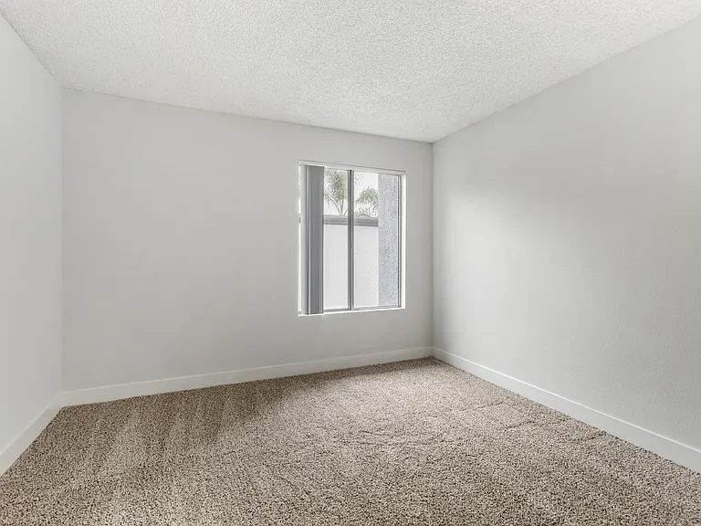 Discover modern comfort and serenity in our freshly renovated bedrooms, where pristine white walls meet plush new carpeting, creating your perfect sanctuary at Cornerstone Apartments.