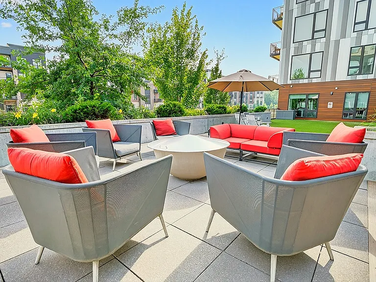 Unwind by the fire with cozy seating and lush surroundings at our zen garden's fire pit, perfect for evening hangouts.