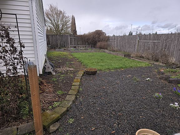 Fenced backyard with planter boxes