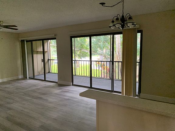 Spacious living room/ dinning room with brand new waterproof flooring . Oversized balcony with storage closet, overlooking a quiet and pleasant backyard