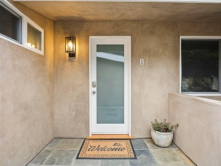 Front entrance of Clifton Street, at end of driveway and next to detached garage.