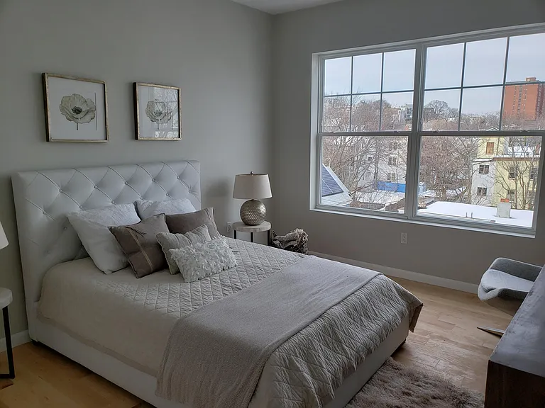 Primary bedroom (as staged, new wood flooring as seen in later photos). Have since added smart home, motorized window treatments.