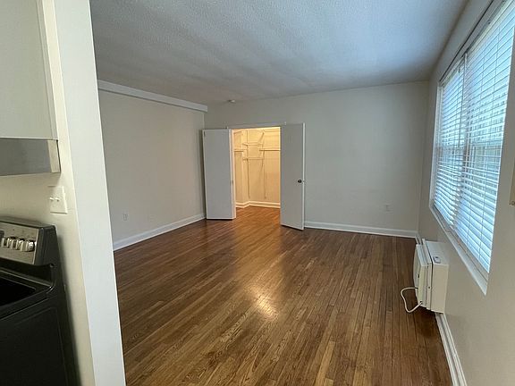 Main living area with kitchen to left and view of walk-in closet