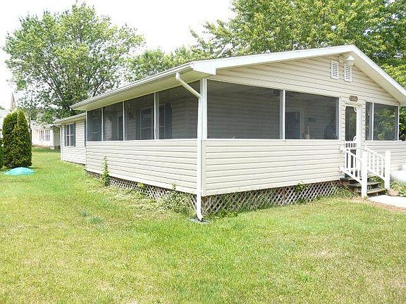 Side yard with view of wrap around screened porch. Wait till you see the mountain views!!