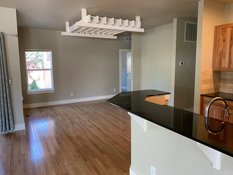 Granite bar top looking into dining room. Hardwood floors