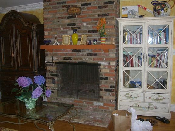 Beautiful floor to ceiling, brick fireplace, and hardwood floors in the living room. All walls are painted beautifully white.! Creating a light and every feeling