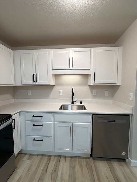 New shaker cabinets with sleek black hardware and under cabinet lighting