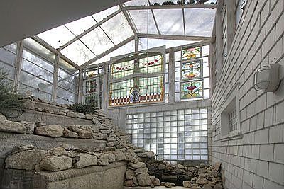 attached green house with a soothing pond