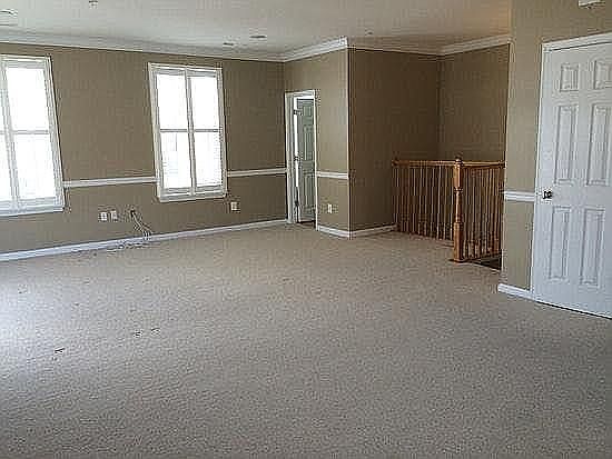 Living Area - Door to 1/2 Bath - Stairs to attached garage - door to closet