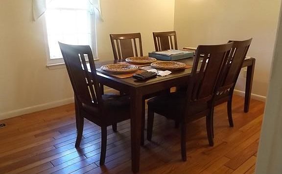 Spacious dining room with hardwood floors.