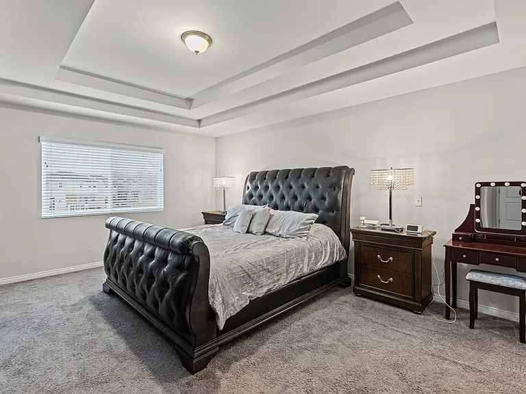 Primary Bedroom with beautiful trayed ceilings and attached bath with spa tub and shower