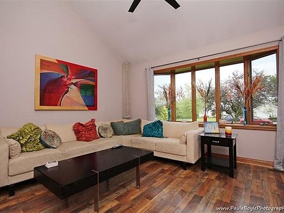 Living room with vaulted ceilings and new wood floor.