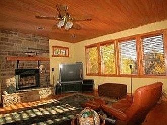 Family room has view of mountains and fireplace.
