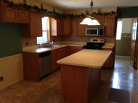 Island-Stainless Steel Appliances-Tile Backsplash-Tile Floor