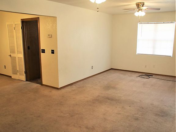 Entrance show largest part of living room and door to kitchen.