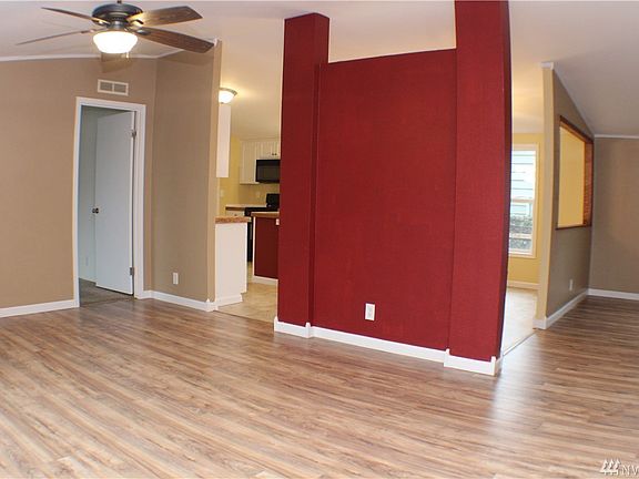 Front living room with vaulted ceilngs and open concept kitchen and dining area