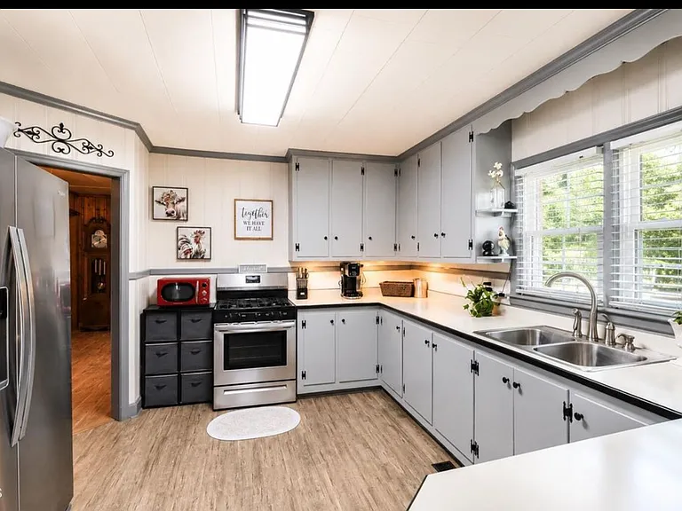 Large kitchen with gas stove and side by side refrigerator with ice/water in door.