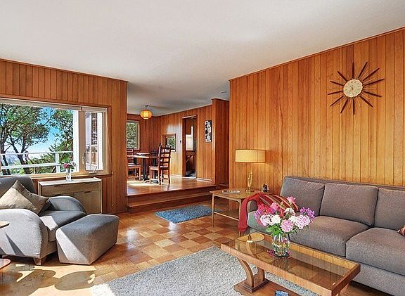 Sunken living room leads to formal dining room.