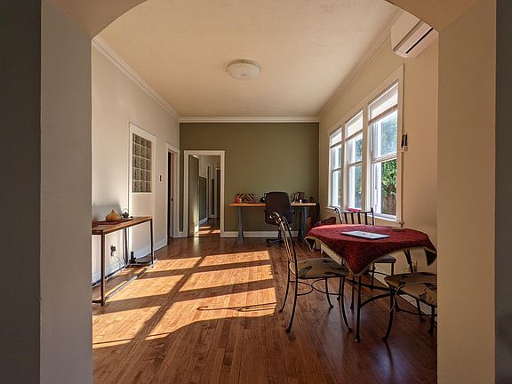 Freshly done wooden floors and plenty of light. This photo is from the first smaller living room into the main living room; two rooms, but connected by an arch. Bedroom is to the left of the arch